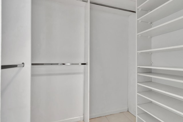 spacious closet featuring light tile patterned flooring