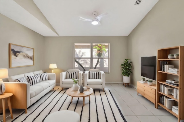 living area with light tile patterned floors, a ceiling fan, visible vents, baseboards, and vaulted ceiling