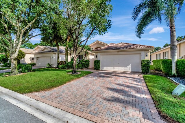 view of front of home with a front lawn and a garage