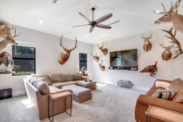 carpeted living room with ceiling fan