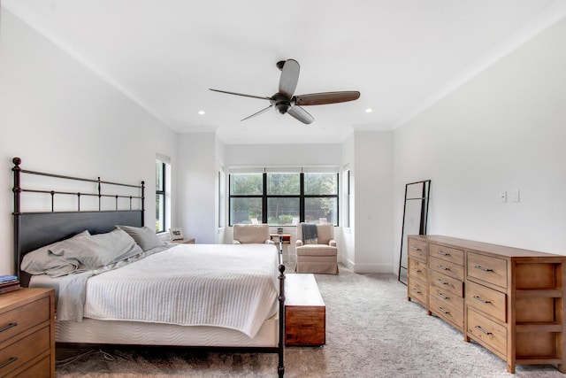 carpeted bedroom with ceiling fan and ornamental molding