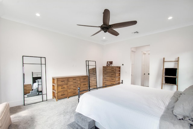 carpeted bedroom with ceiling fan and crown molding