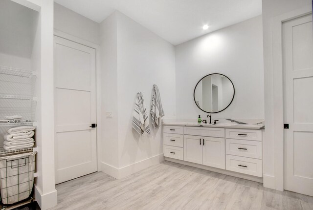 bathroom featuring vanity and hardwood / wood-style floors