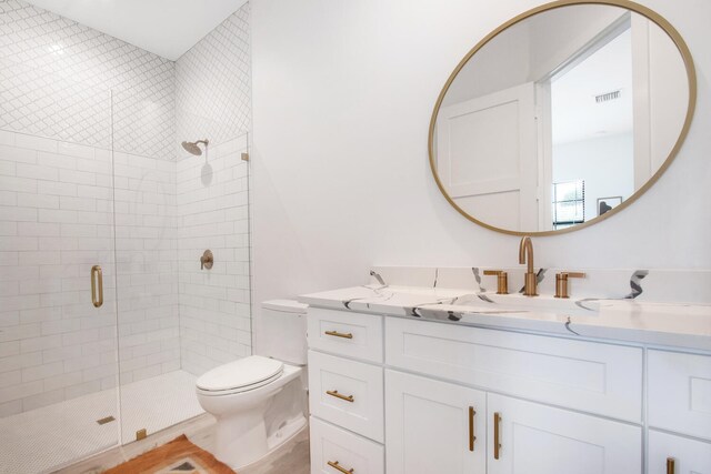 bathroom featuring vanity, toilet, and walk in shower