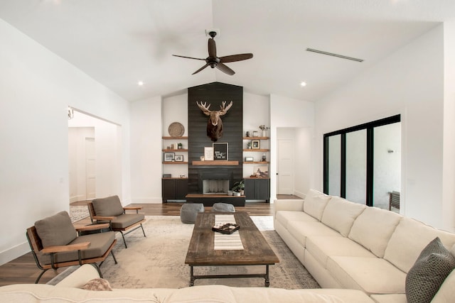 living room featuring lofted ceiling, ceiling fan, and hardwood / wood-style flooring