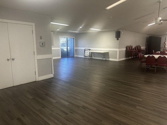 interior space with ceiling fan and dark wood-type flooring