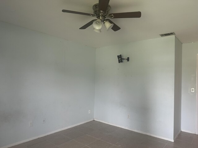 spare room featuring tile patterned floors and ceiling fan