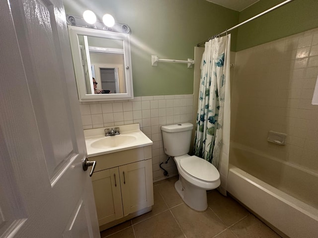 full bathroom with vanity, tile patterned floors, toilet, tile walls, and shower / tub combo