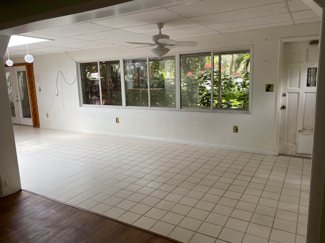 spare room with a paneled ceiling and ceiling fan