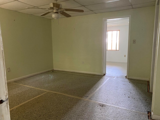 spare room featuring a drop ceiling and ceiling fan