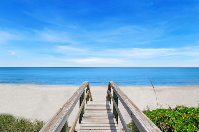 view of property's community featuring a water view and a view of the beach