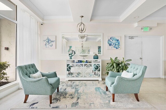 sitting room featuring tile patterned flooring, crown molding, and a tray ceiling