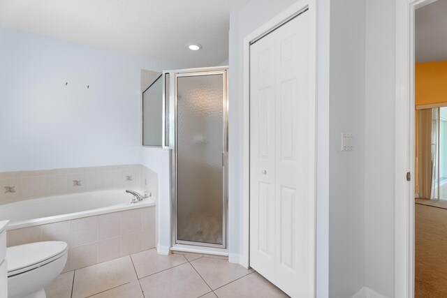 bathroom with toilet, tile patterned floors, and plus walk in shower