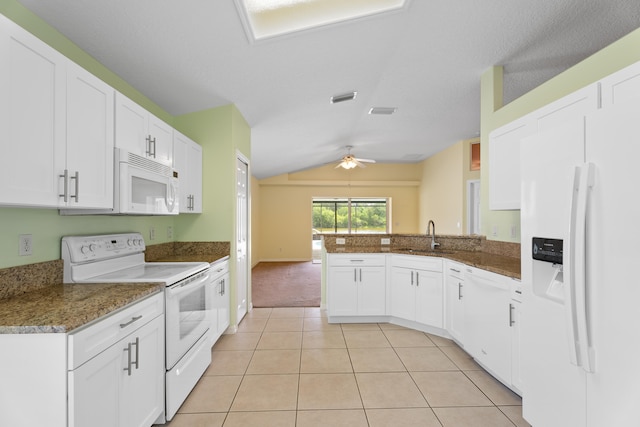 kitchen with white appliances, kitchen peninsula, white cabinetry, lofted ceiling, and ceiling fan