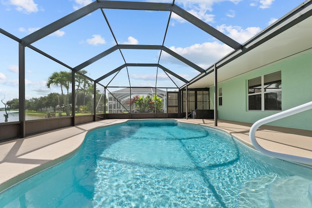 view of swimming pool featuring a lanai and a patio