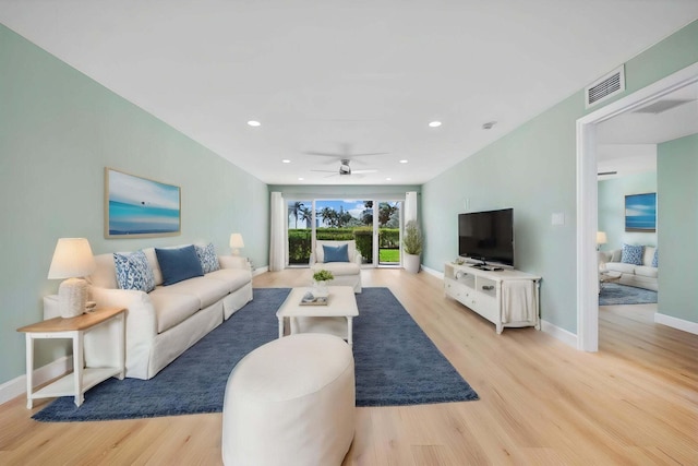 living room with ceiling fan and light hardwood / wood-style floors