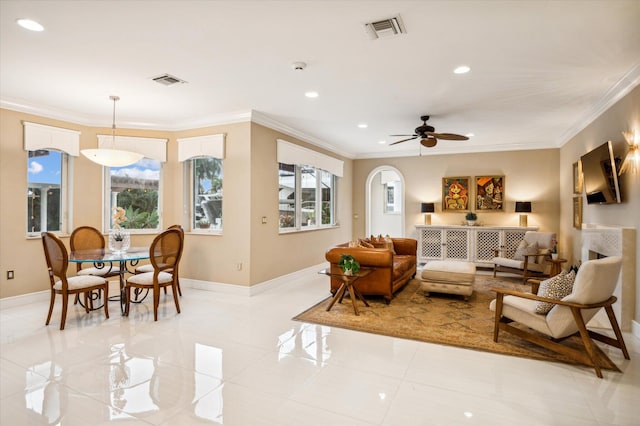 living room featuring ornamental molding, a healthy amount of sunlight, and light tile patterned flooring