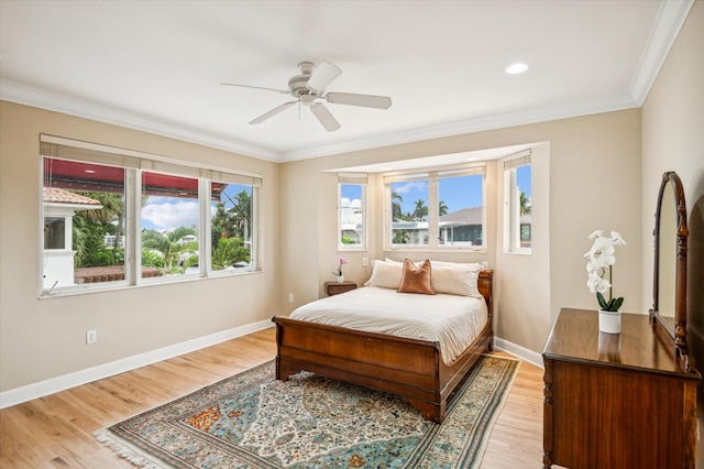 bedroom with hardwood / wood-style floors, ceiling fan, and ornamental molding