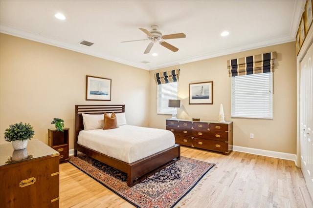 bedroom featuring ceiling fan, a closet, ornamental molding, and light wood-type flooring