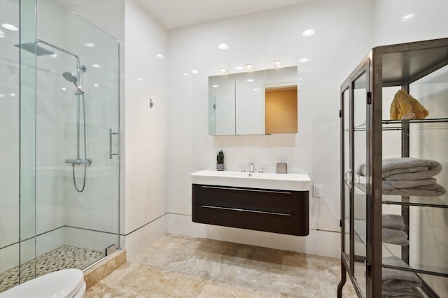 bathroom featuring toilet, an enclosed shower, and vanity