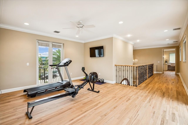 exercise area with ceiling fan with notable chandelier, light hardwood / wood-style floors, and ornamental molding