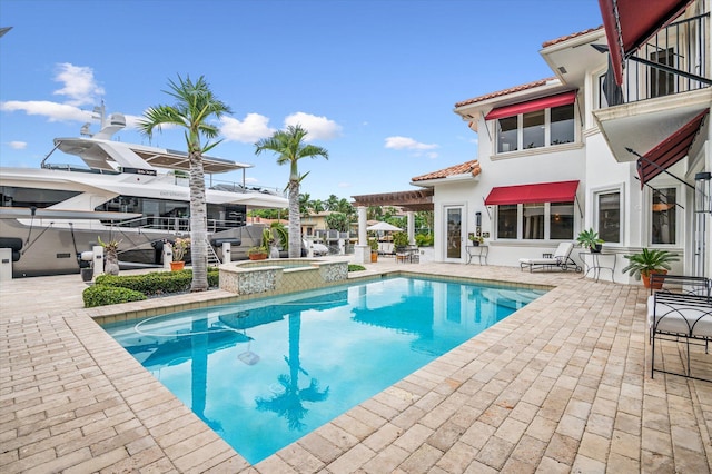 view of swimming pool featuring a pergola, an in ground hot tub, and a patio