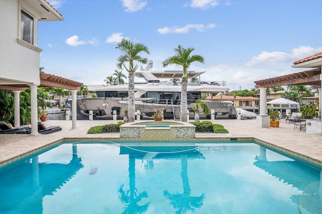 view of swimming pool featuring a pergola, an in ground hot tub, and a patio