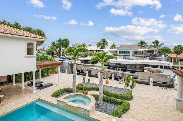 view of swimming pool featuring an in ground hot tub and a patio