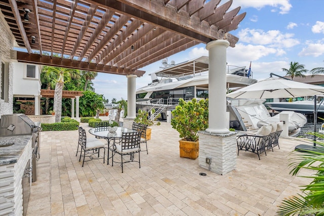 view of patio with a pergola, an outdoor kitchen, and a grill