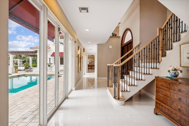 hallway featuring a wealth of natural light and ornamental molding