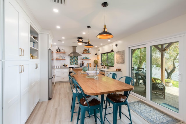 dining space with light wood-type flooring