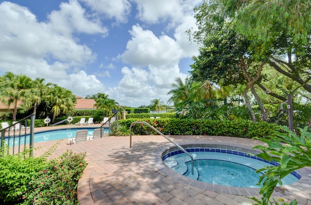 view of swimming pool featuring a patio area and a community hot tub