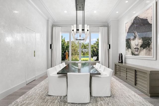 dining space featuring ornamental molding and light hardwood / wood-style flooring