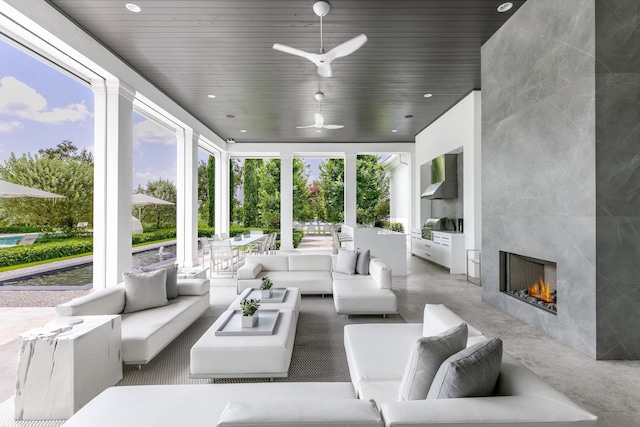 sunroom / solarium with a tile fireplace and wooden ceiling