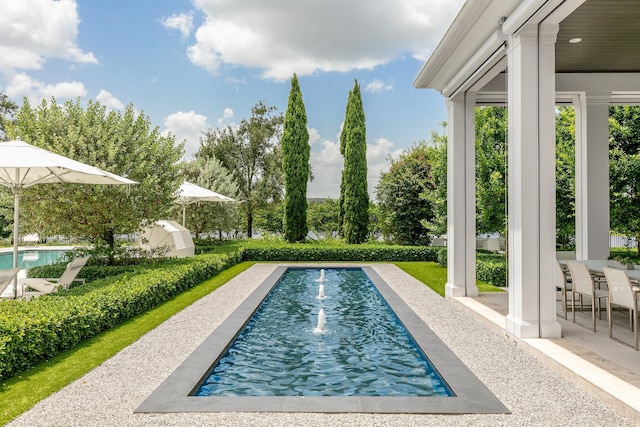 view of swimming pool featuring a patio area and pool water feature