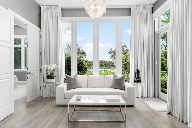 sunroom / solarium featuring a chandelier