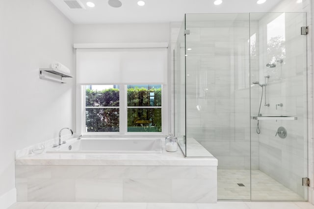 bathroom with independent shower and bath and tile patterned flooring