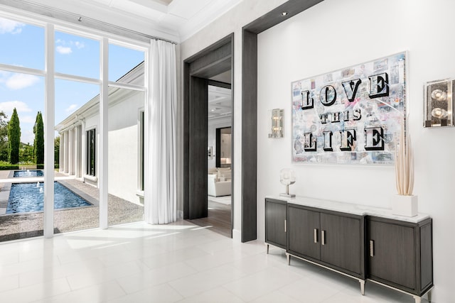 interior space with crown molding and light tile patterned floors