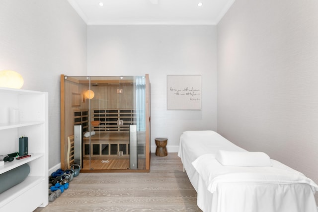 bedroom with crown molding and hardwood / wood-style flooring