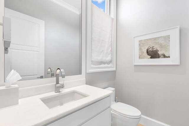 bathroom featuring toilet and vanity