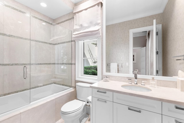 full bathroom with crown molding, vanity, shower / bath combination with glass door, and toilet