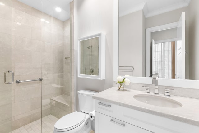 bathroom featuring an enclosed shower, vanity, ornamental molding, and toilet