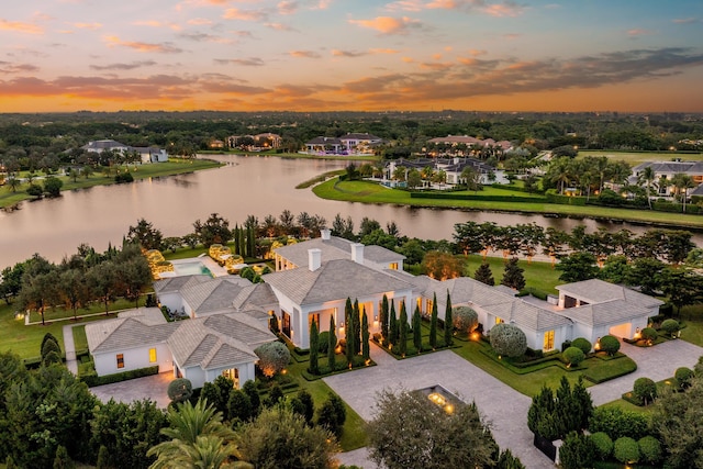 aerial view at dusk with a water view