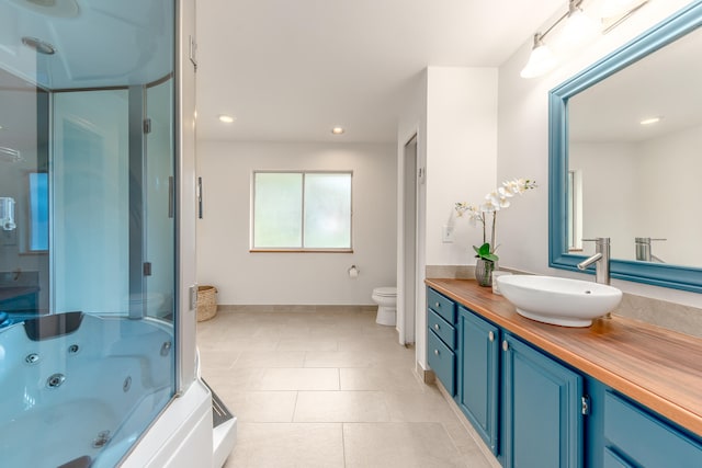 full bathroom featuring plus walk in shower, tile patterned flooring, toilet, and vanity