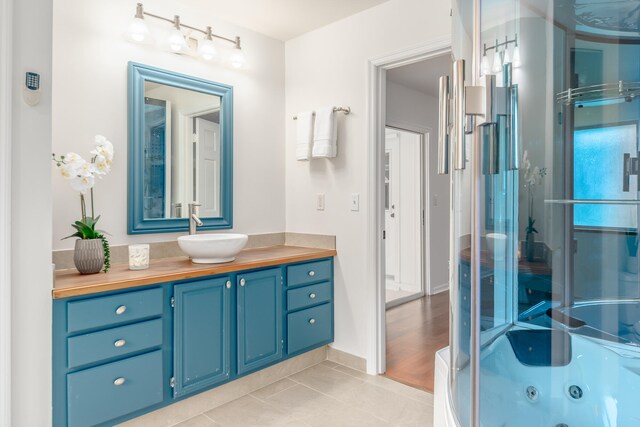 bathroom with vanity, wood-type flooring, and walk in shower