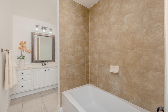 bathroom with a tub, tile patterned floors, and vanity