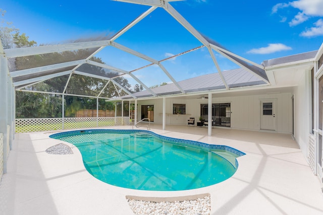 view of swimming pool featuring a lanai, ceiling fan, and a patio