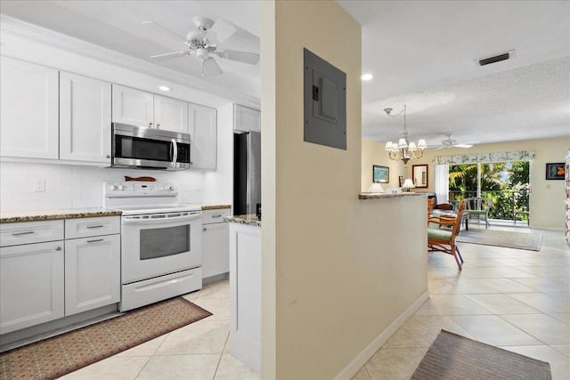 kitchen with ceiling fan with notable chandelier, a textured ceiling, white cabinetry, stainless steel appliances, and electric panel