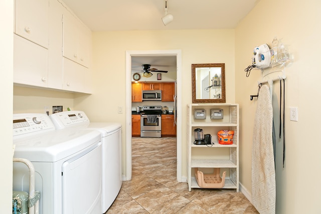 washroom featuring cabinets, washing machine and dryer, and ceiling fan