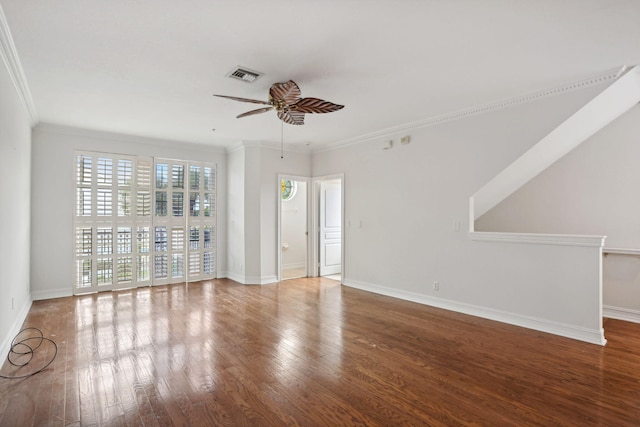 empty room with ceiling fan, ornamental molding, and hardwood / wood-style flooring